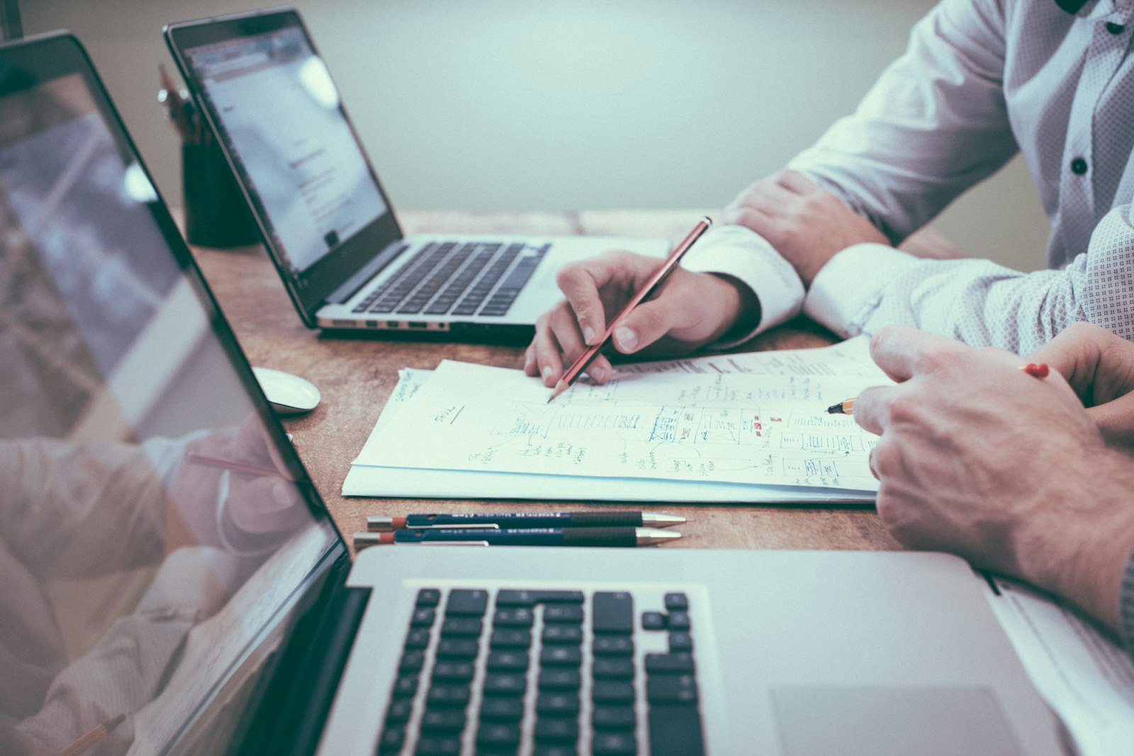 Laptop and documents on a desk — climate reporting and carbon inventory work